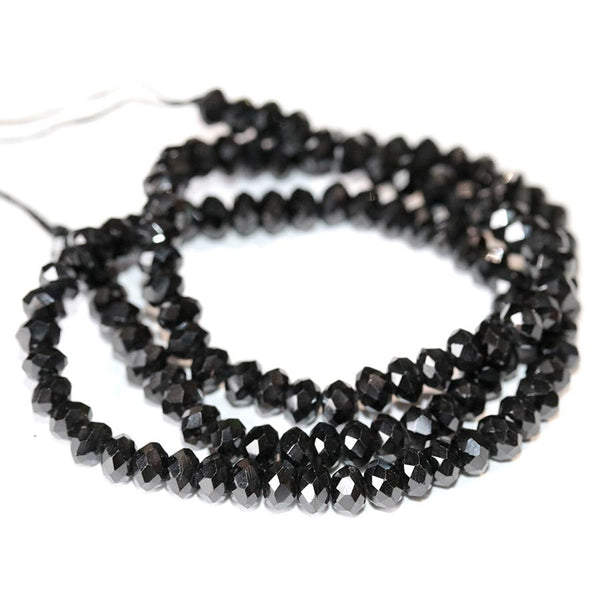 This is a Dakota Stones 6mm Black Spinel Diamond Cut Gemstone strand with faceted rondelle beads in 15-16 inch strand.