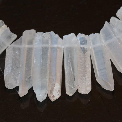 This is a Dakota Stones 6x16-8x38mm Pch Lt Light Peach Crystal Gemstone strand of round beads in 15-16 inch strand.