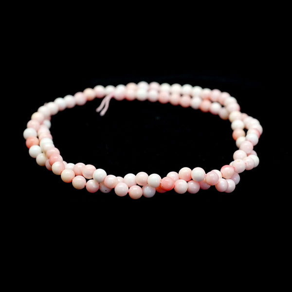 This is a Dakota Stones 4mm Queen Conch Shell Gemstone strand with round beads in 15-16 inch strand.