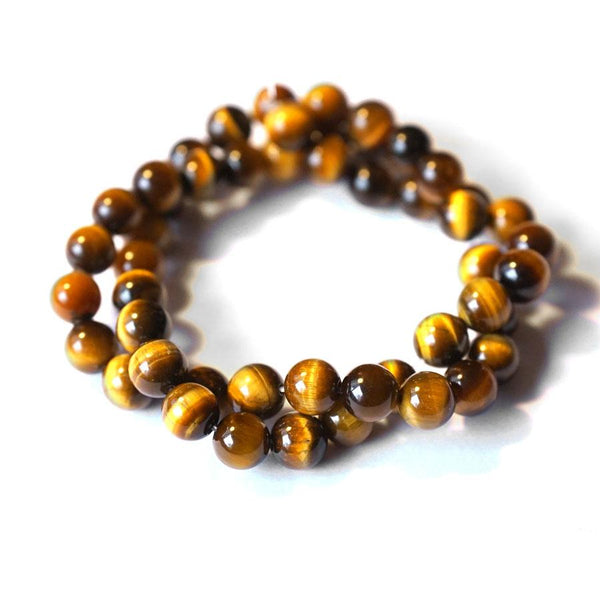 This is a Dakota Stones 8mm Tiger Eye Gemstone strand with round beads in 15-16 inch strand.